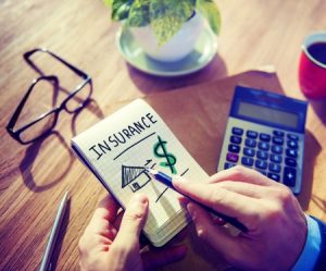 Businessman with Notepad on Home Insurance Cost