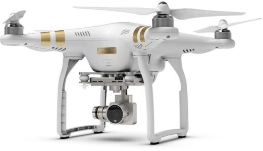 We are excited to have the option of aerial drone roof inspections, at no-charge, as an as-needed service with our home inspection. If we can’t safely see 100% of a roof, we can use a remote-controlled drone to fly over the house and photograph or video the roof from above. A white quadcopter drone with a mounted camera and gold accents is shown on a plain background.